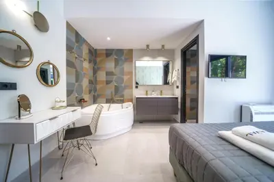 a bathroom with a bed and a tub and a sink at Naval villa-Panoramic villa with heated pool on the roof in Gerani Chanion