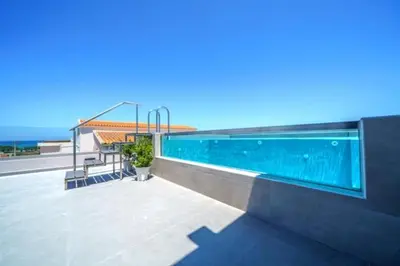 a swimming pool on the side of a building at Naval villa-Panoramic villa with heated pool on the roof in Gerani Chanion