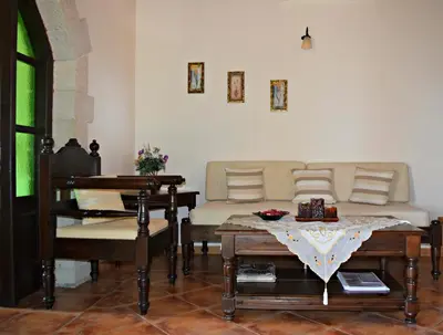 a living room with a couch and a table at Aspalathos Villas in Fílippos