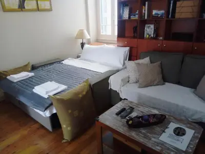 a room with two beds and a couch and a table at Neoclassical Glamour in Chania Town