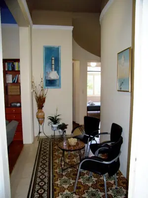 a living room with chairs and a table at Neoclassical Glamour in Chania Town