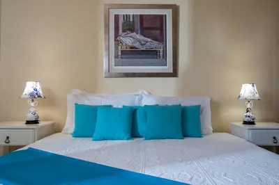 a bedroom with a bed with blue pillows at Villa Anerocurù by Chania city in Chania Town