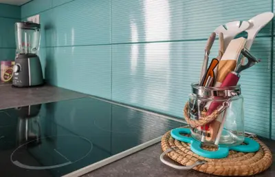 a glass jar filled with utensils on a counter at Veranda Apartment in Chania Town