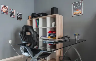 a desk with a black chair and a book shelf at Veranda Apartment in Chania Town