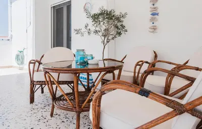 a dining room with a table and chairs at Veranda Apartment in Chania Town