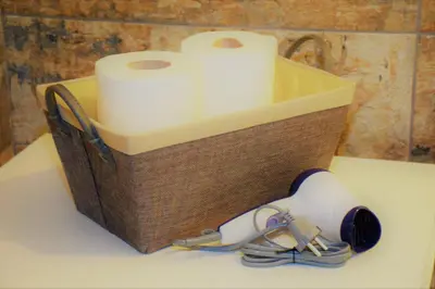 a wooden basket with two rolls of toilet paper at The Manor House in the Old Town in Chania Town
