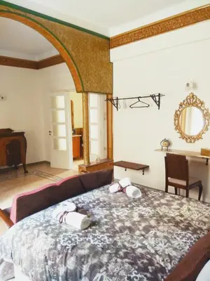 a bedroom with a bed with two shoes on it at The Manor House in the Old Town in Chania Town