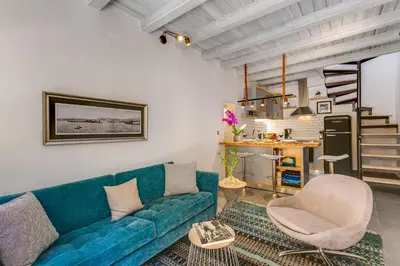 a living room with a blue couch and a chair at Casa Minaretto in Chania Town