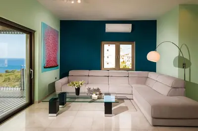 a living room with a couch and a table at Blue Sea Chania Villa in Chania Town