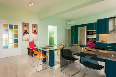 a dining room with a glass table and chairs at Blue Sea Chania Villa in Chania Town