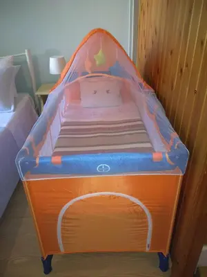 a childs bed with an orange and blue canopy at Minaret's View ζήστε στην αύρα της παλιάς πόλης in Chania Town