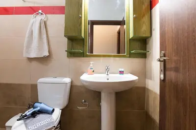 a bathroom with a sink and a toilet and a mirror at Nikis Apartments Kisamos in Drapaniás