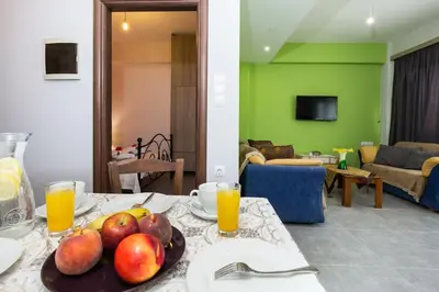a plate of fruit on a table in a living room at Nikis Apartments Kisamos in Drapaniás