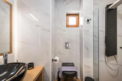 a bathroom with a sink and a shower at Evlimeni Suites in Chania Town