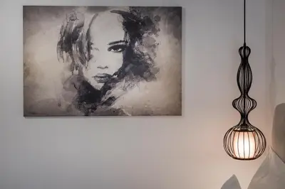 a picture of a woman on a wall with a lamp at Evlimeni Suites in Chania Town