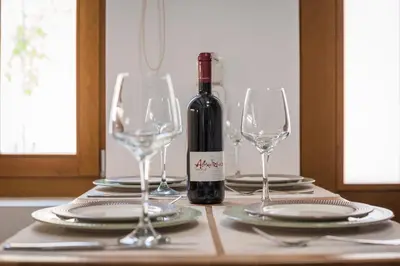 a bottle of wine sitting on a table with glasses at Evlimeni Suites in Chania Town
