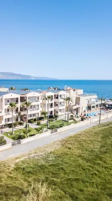 a view of the beach and buildings at a resort at Maleme Mare in Maleme