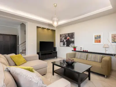 a living room with a couch and a tv at Villa Athinais in Gerani Chanion