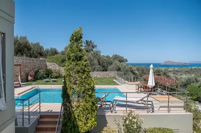a villa with a swimming pool and a view of the ocean at Villa Athinais in Gerani Chanion