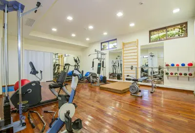 a gym with several treadmills and exercise bikes at ERIA RESORT for people with special abilities in Maleme
