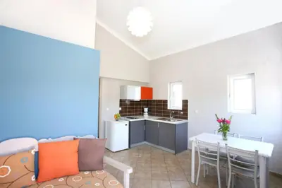 a kitchen and living room with a couch and a table at Elea in Kato Daratso