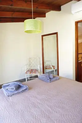 a bedroom with a large bed with a mirror at Elea in Kato Daratso