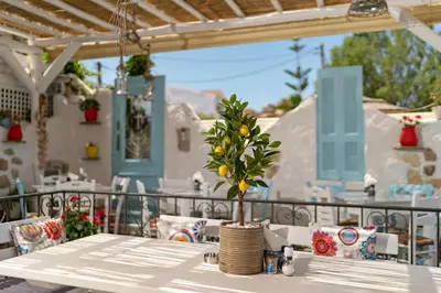 a table with a lemon tree on a patio at Sonio Beach - Que Bella Collection in Plataniás