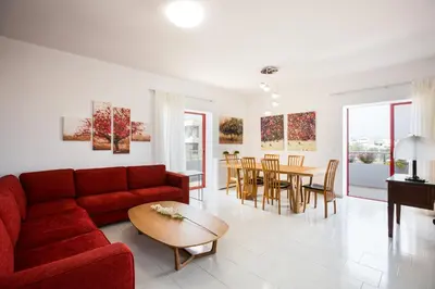 a living room with a red couch and a table at La Vita Moderna in Chania Town