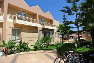a building with bikes parked in front of it at Castro Beach Hotel in Maleme