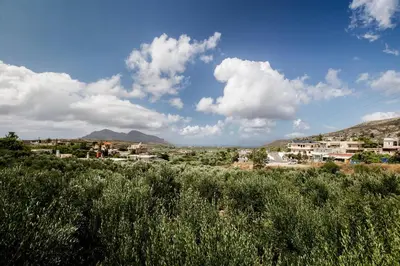 a view of a town with mountains in the background at Margarita's Stone House in Plátanos