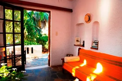 a living room with a red bench and a sliding glass door at Kalives Apartments in Kalyves