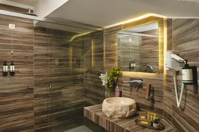 a bathroom with a sink and a mirror at Elia Palazzo Hotel in Chania Town