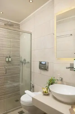 a bathroom with a toilet and a sink and a shower at Elia Palazzo Hotel in Chania Town