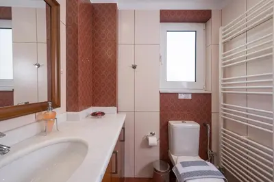 a bathroom with a tub and a toilet and a sink at Casa Magnolia in Katokhórion