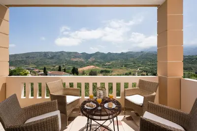 a balcony with chairs and a table with a view at Casa Magnolia in Katokhórion