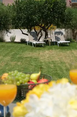 a plate of fruit on a table in a park at Olive Garden Holiday Home steps to Beach 1 in Kato Daratso