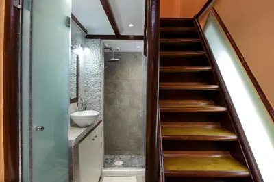 a staircase in a bathroom with a sink and a shower at Sali Chelidonaki boutique suite in Chania Town