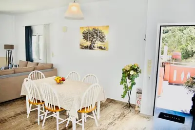 a dining room with a table and chairs at Cozy Renovated Apartment 
