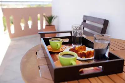 a tray with cups of coffee and pastries on a table at Cozy Renovated Apartment 