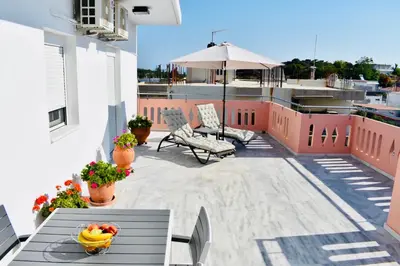 a balcony with a table with a bowl of fruit on it at Cozy Renovated Apartment 