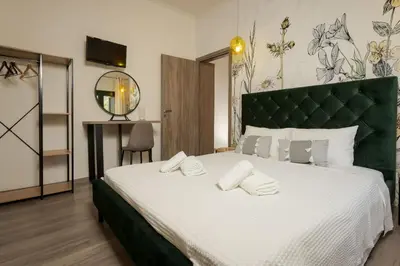 a bedroom with a large bed with a green headboard at Zen Villa Elafonisi in Kamára
