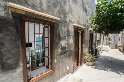 a building with windows on the side of a street at kito- transformed house on the water's edge in Chania Town