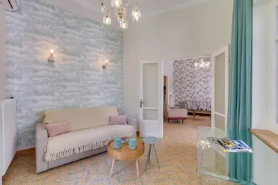 a living room with a couch and a table at Samouil Apartment steps from the beach in Chania Town