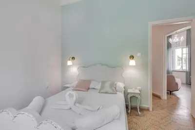 a white room with a bed and a couch at Samouil Apartment steps from the beach in Chania Town