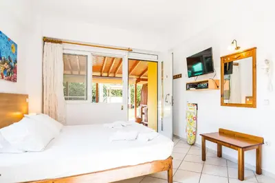 a bedroom with a bed and a window and a table at Thalassa Apartments in Kissamos