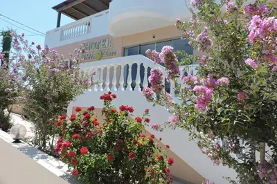 a garden of flowers on a white wall at Golden Rose Suites in Kolymvari