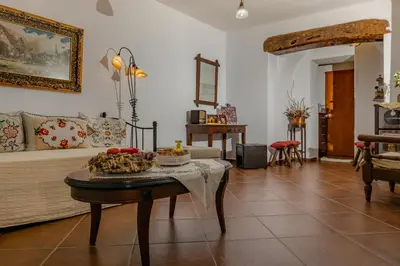 a living room with a table with food on it at Cottage home at South Chania in Grigorianá