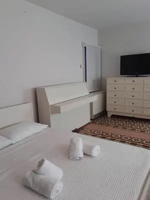 a bedroom with a bed with towels on it at White Rose in Chania Town