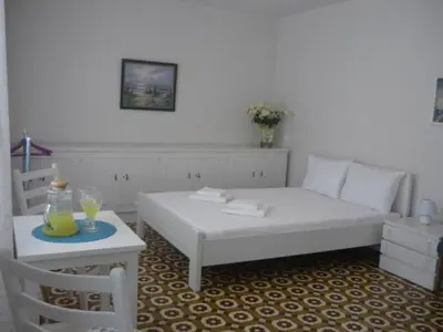 a living room with a white couch and a table at White Rose in Chania Town