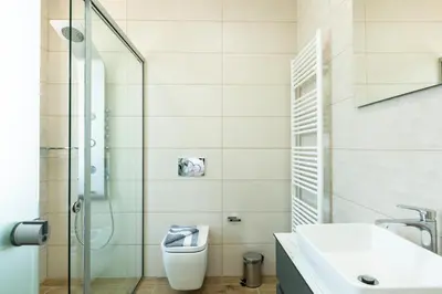a bathroom with a shower and a toilet and a sink at Eudora Luxury Stone Villa in Almirida